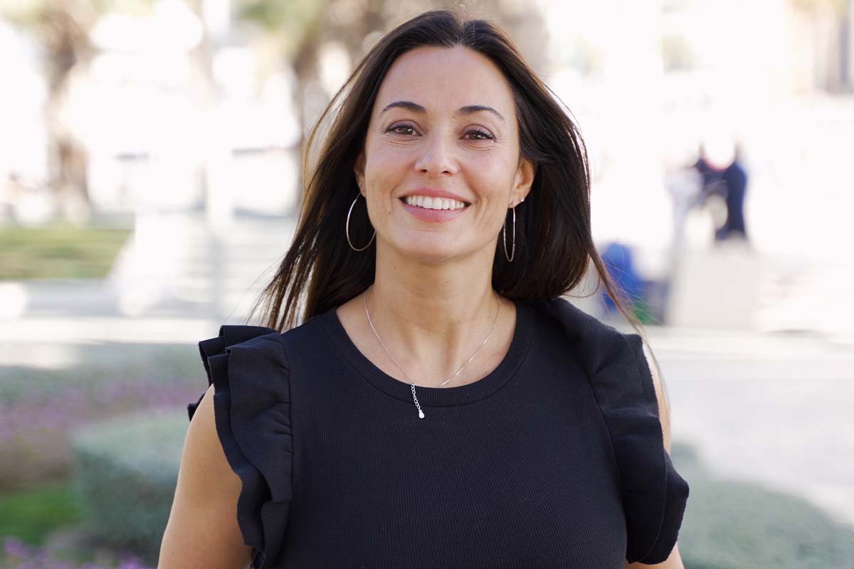 a woman smiling after getting blepharoplasty in Raleigh