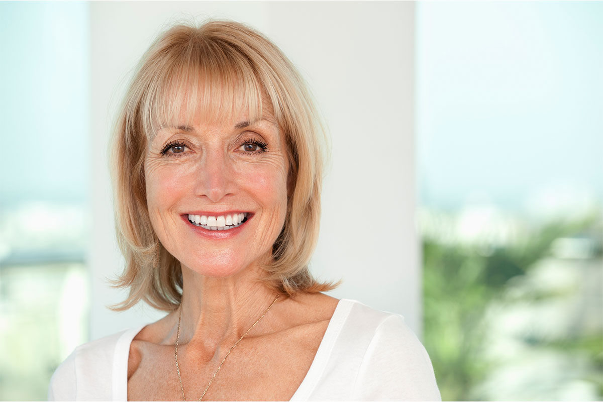 a woman smiling after seeing a facelift specialist in Raleigh at Stein Plastic Surgery